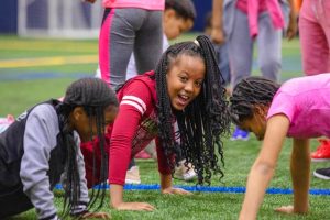 A group of girls laughing as they exercise on ACES Day