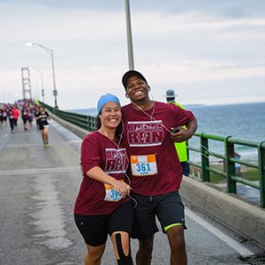 Couple while running across the Mackinaw Bridge
