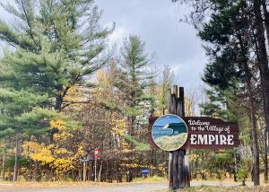 Sign that says, "Welcome to the Village of EMPIRE" by Mackinac Design