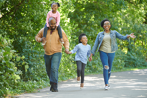 Family taking a walk on the Lansing River Trail