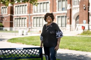 Fannie Johnson standing outside a brick school