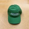 Green hat with white embroidery of the Farmers Market Food Navigator logo on it.