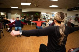 GFHC Senior Citizens doing chair exercises.