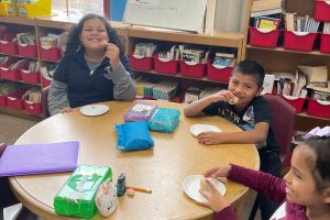 Kids smiling around a table