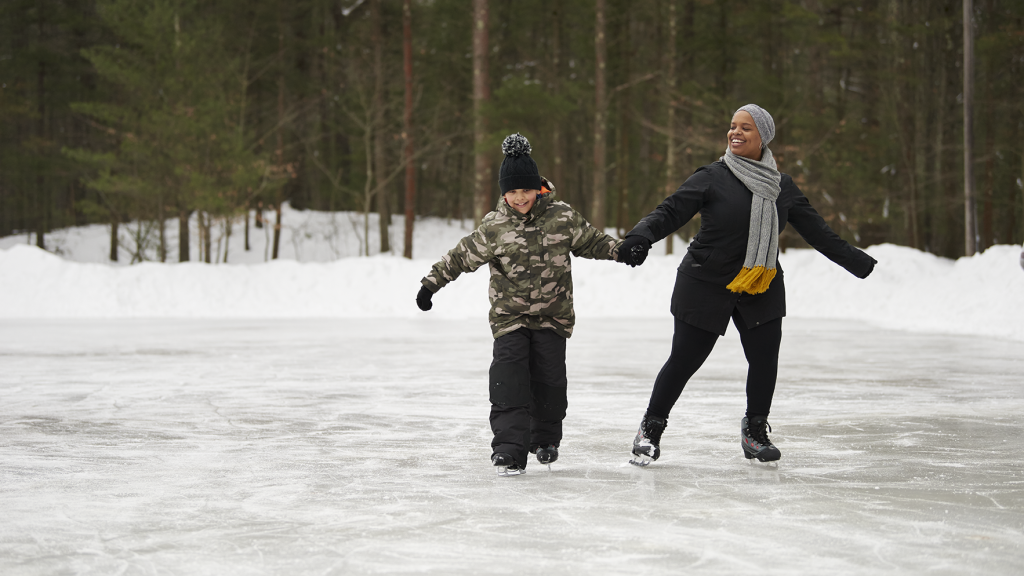 Mother and son ice skating at the Muskegon Luge Adventure Sports Park by Michigan Fitness Foundation