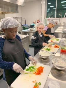 Students chopping vegetables