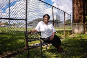 Valerie Middlebrook sitting outside by a track.